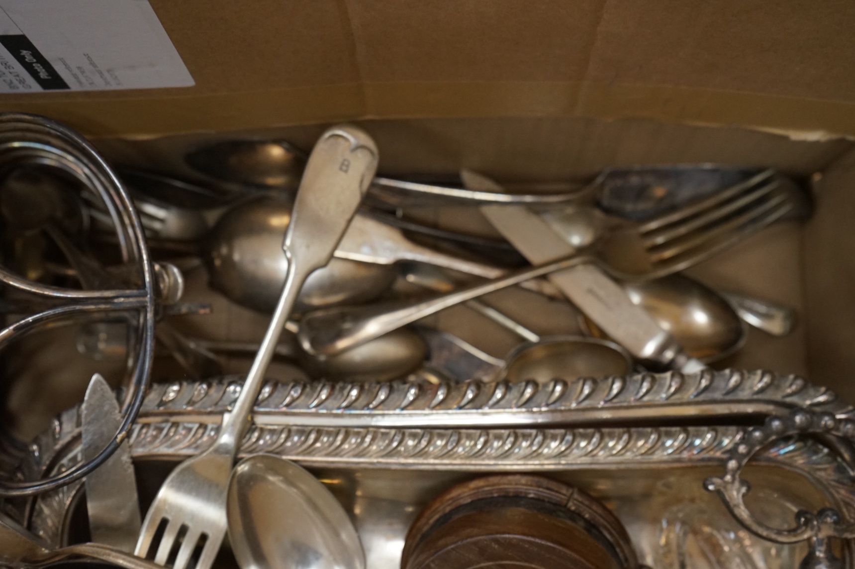 A group of assorted plated items including entree dishes, flatware and wine coaster.